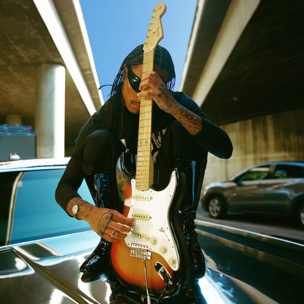Steve Lacy posing with his Signature Fender "People Pleaser" Stratocaster