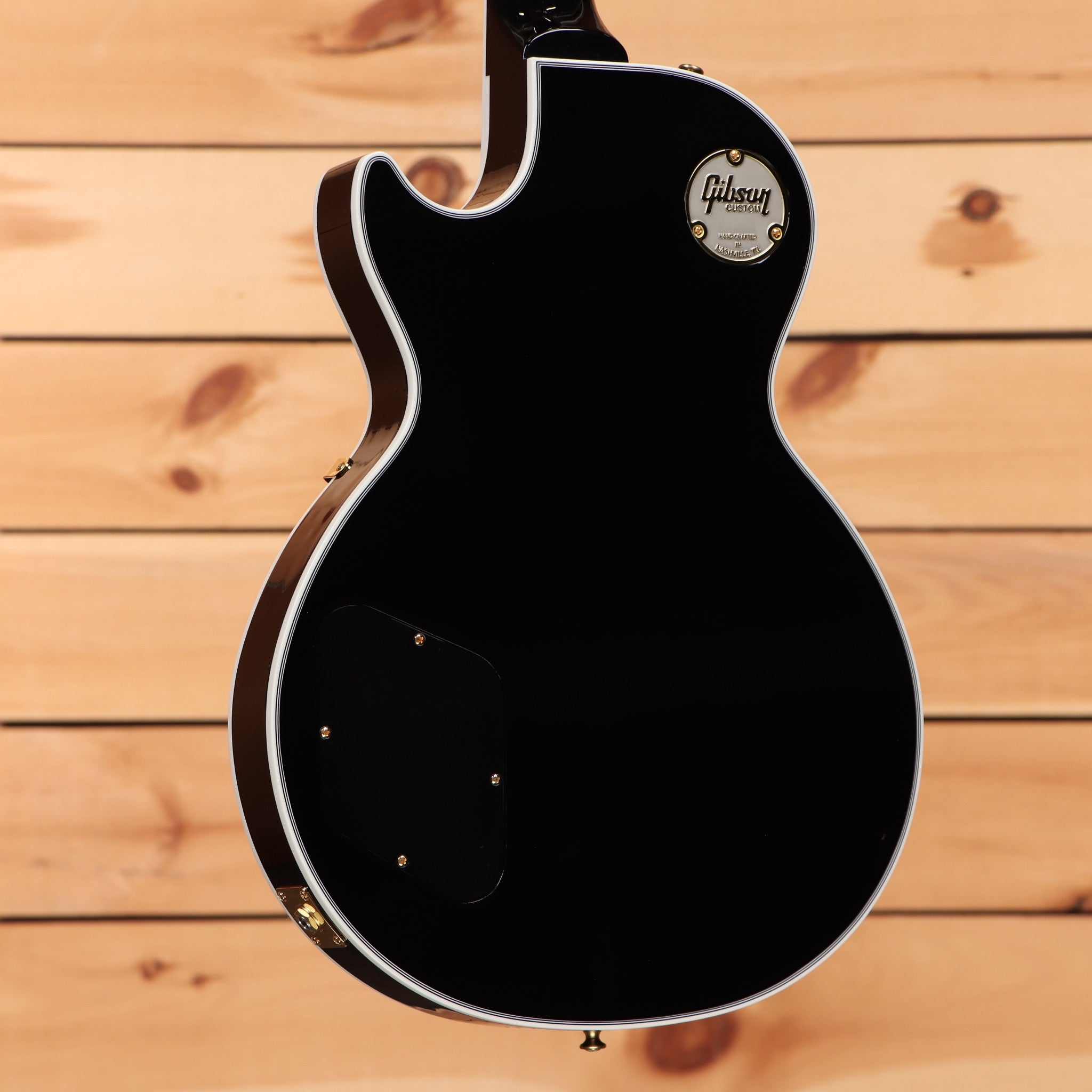 Gibson Les Paul Custom ebony electric guitar with gold hardware and white binding