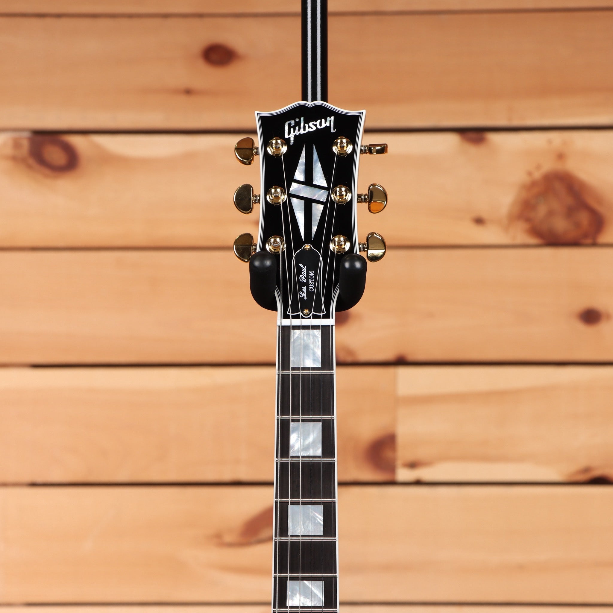 Gibson Les Paul Custom ebony electric guitar with gold hardware and headstock inlay