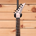 Jackson American Series Virtuoso electric guitar Satin Shell Pink with pointed headstock and black tuning machines