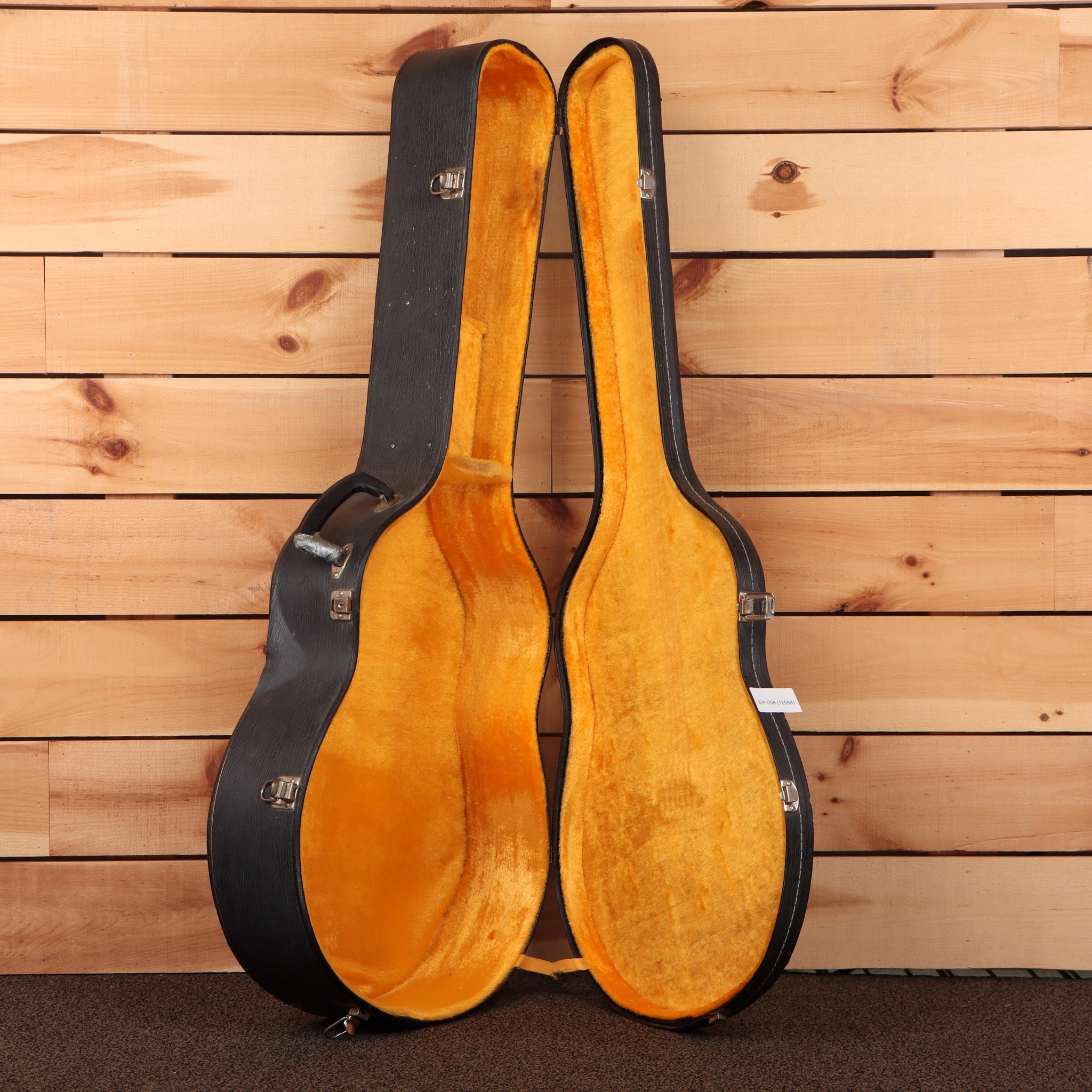 Epiphone FT-570BL acoustic guitar hardshell case open showing gold velvet interior with silver latches