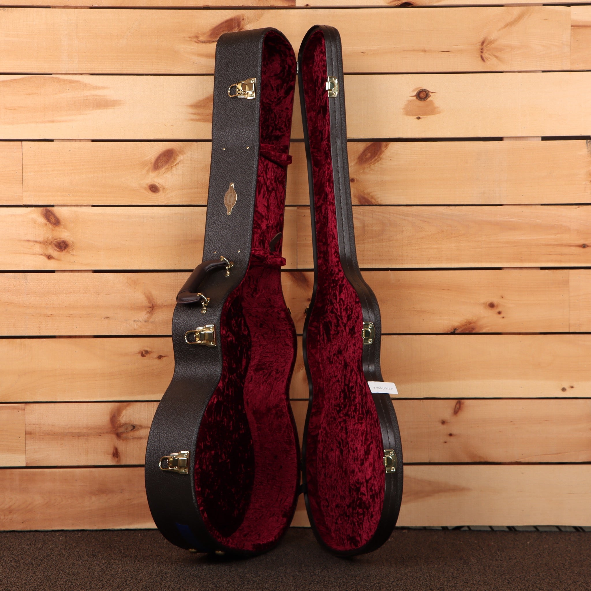 Taylor 724ce acoustic-electric guitar hardshell case black exterior with red velvet interior and gold hardware latches
