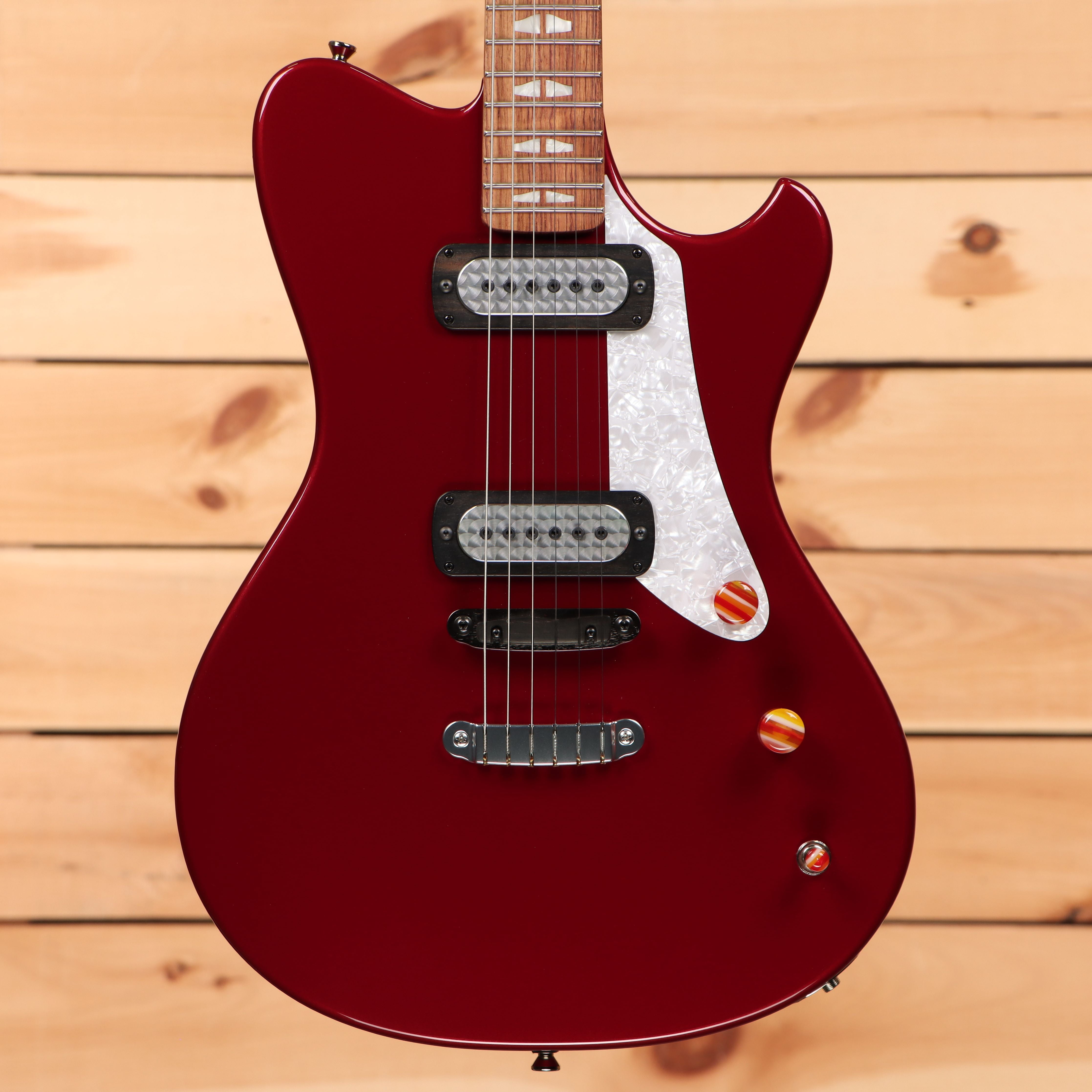 Powers electric A-type hardtail Cherry Bomb guitar with dual humbucker pickups and white pickguard