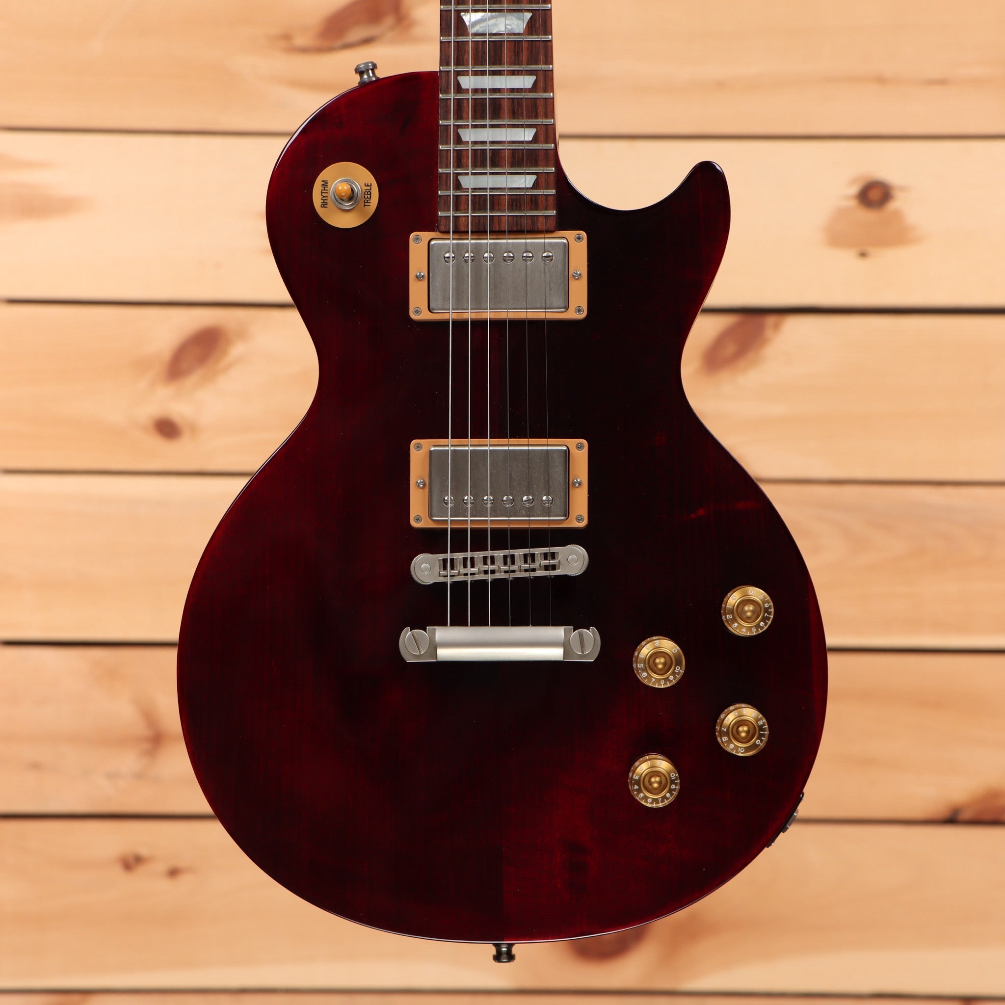 Pre-owned Gibson Les Paul Studio 100th Anniversary electric guitar Wine Red with dual humbucker pickups and gold hardware