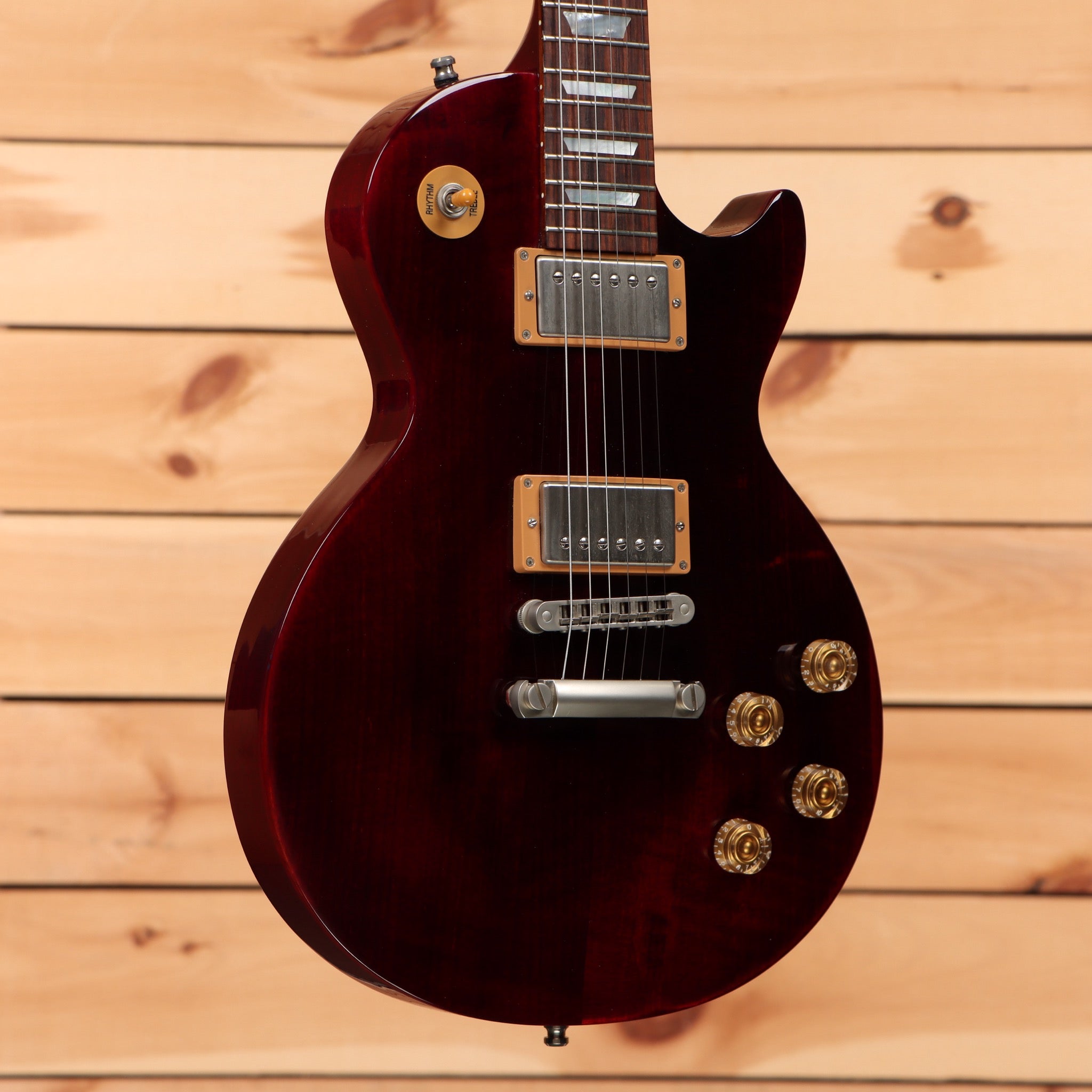 Pre-owned Gibson Les Paul Studio 100th Anniversary electric guitar Wine Red with dual humbucker pickups and gold hardware