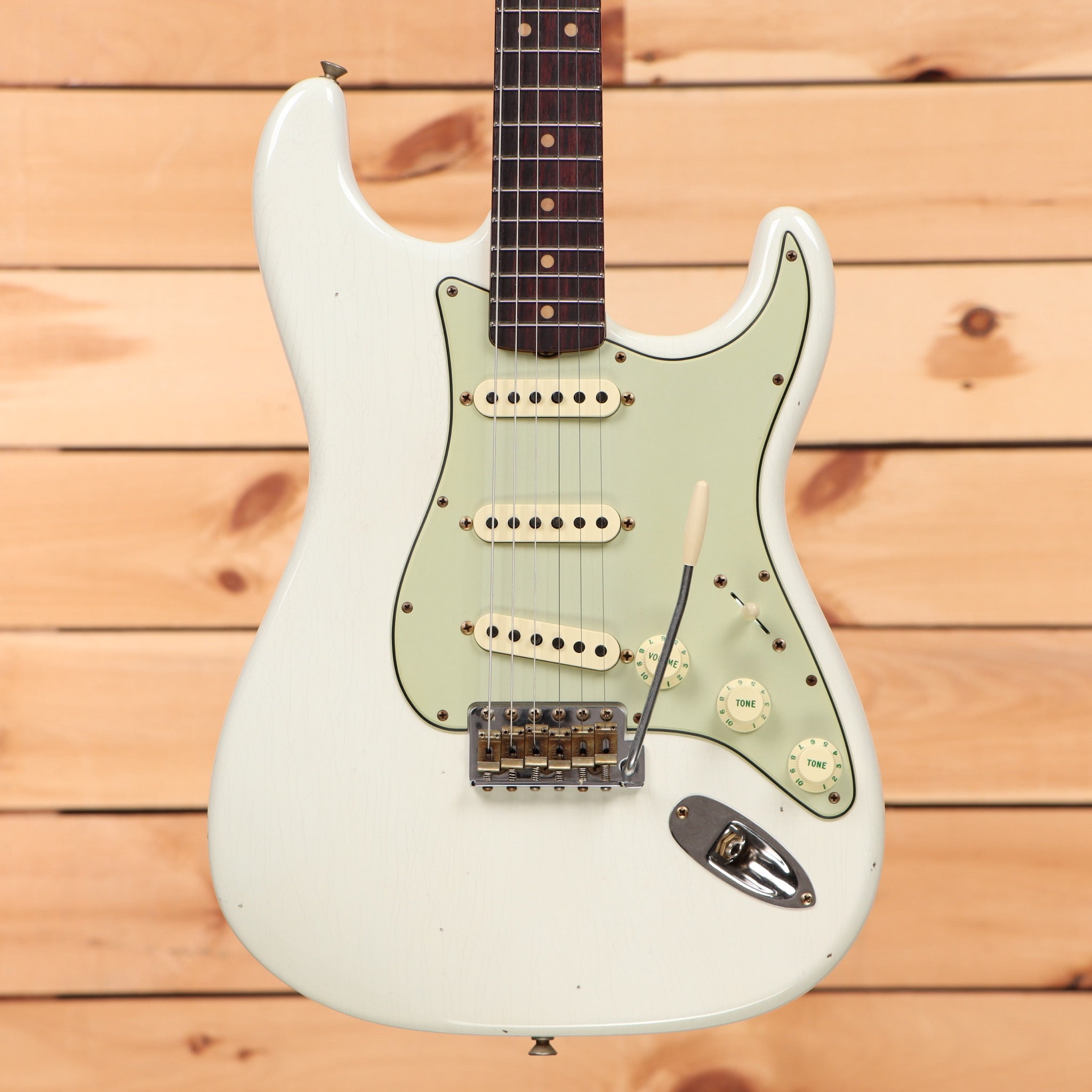 Fender Custom Shop 1964 Stratocaster Journeyman Relic aged Olympic White electric guitar with single-coil pickups