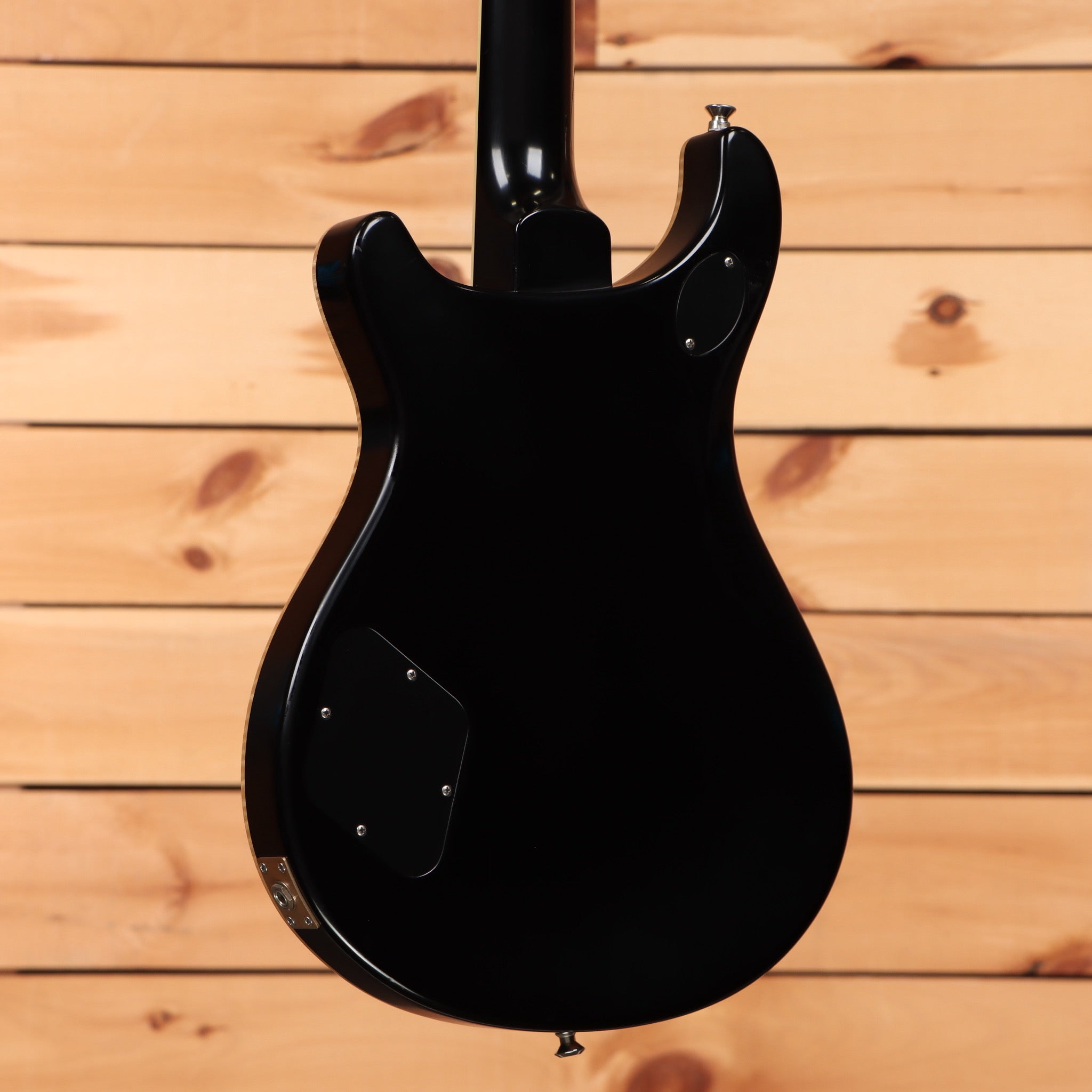 PRS McCarty 594 electric guitar Satin Black showing rear body with cavity cover plates and gloss black neck