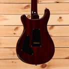 Paul Reed Smith Custom 24 Dark Cherry Sunburst electric guitar with humbucker pickups and black pickguard