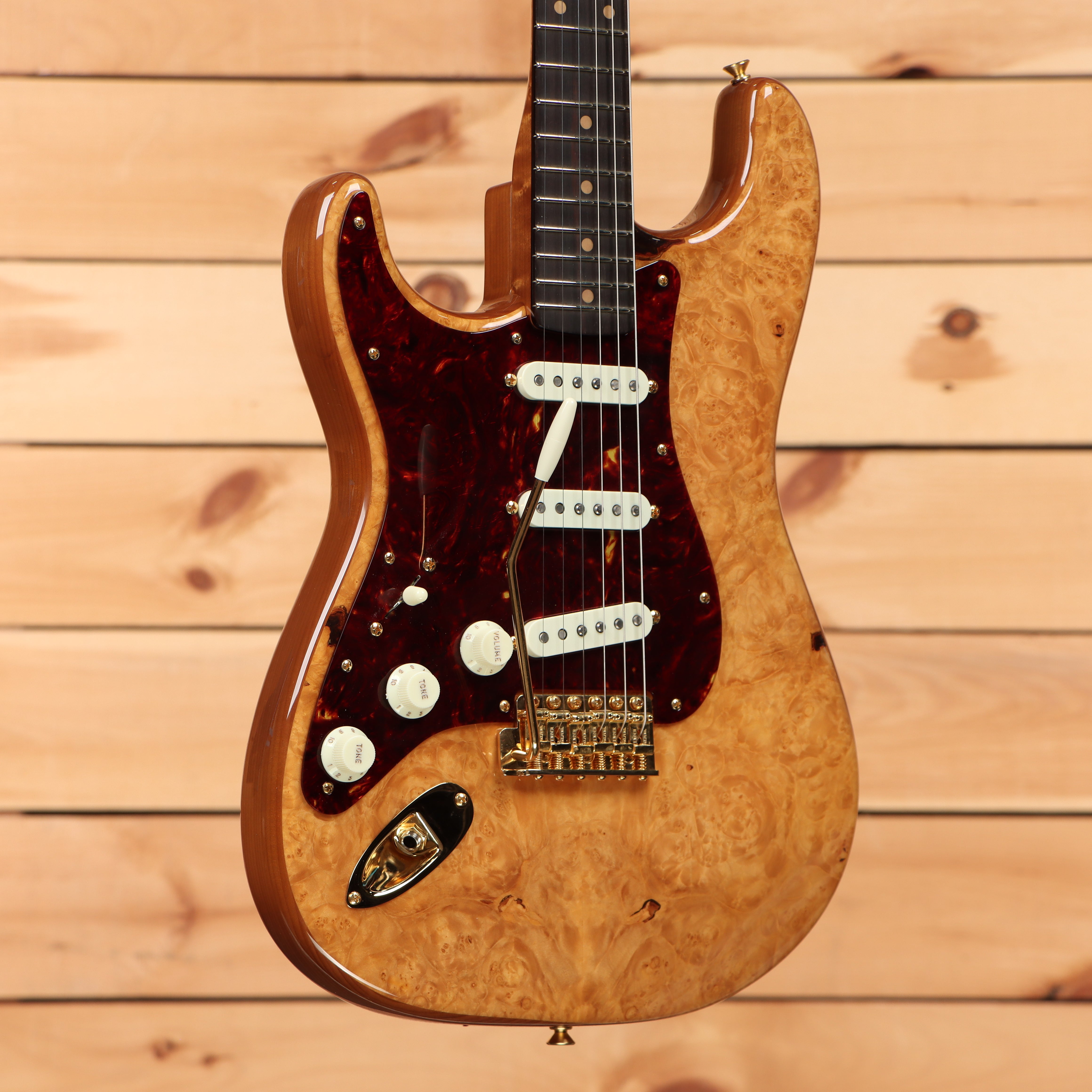 Fender Custom Shop Artisan Maple Burl Stratocaster left-handed electric guitar aged natural with tortoiseshell pickguard and gold hardware