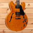 Gibson ES-335 semi-hollow electric guitar Figured Honey Amber with black pickguard and f-holes