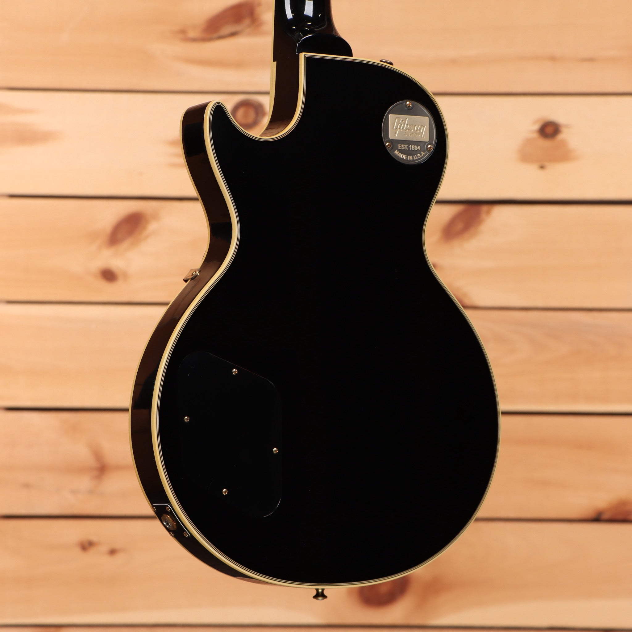 Pre-owned Gibson 1957 Les Paul Custom Reissue electric guitar Ebony VOS with gold binding and dual humbuckers