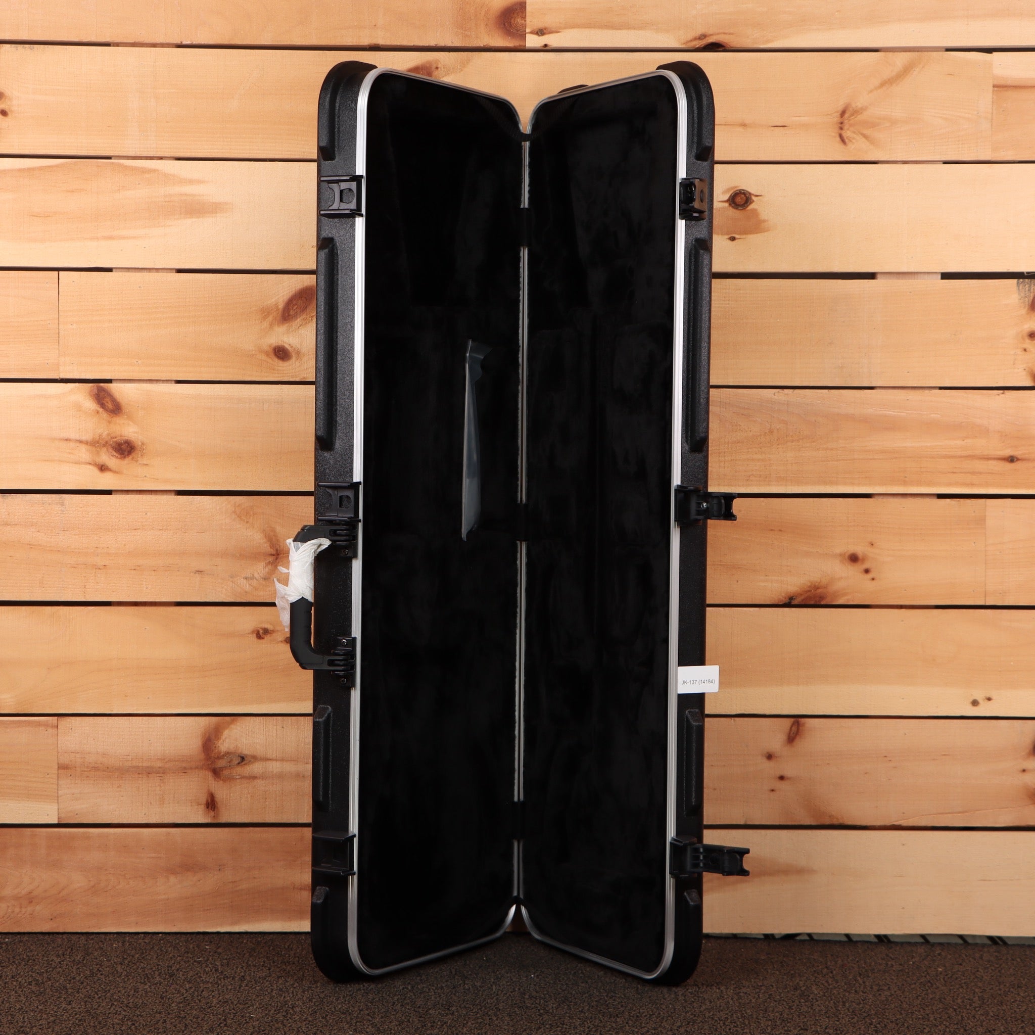 Jackson Righteous Run Custom Soloist guitar hard case open showing black plush interior and ABS molded shell with latches