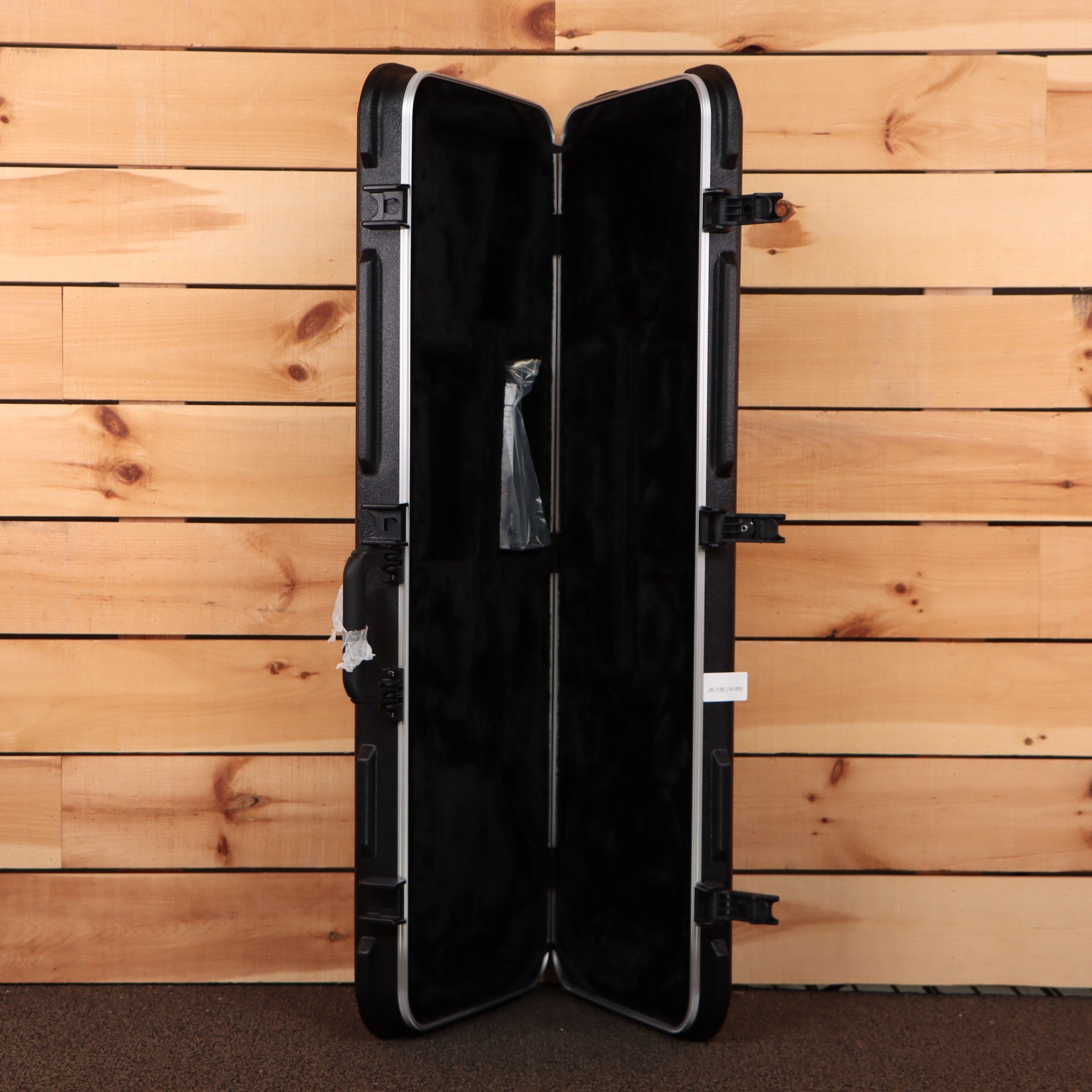 Jackson Righteous Run Custom Soloist hard-shell ABS guitar case open showing black plush interior with latches
