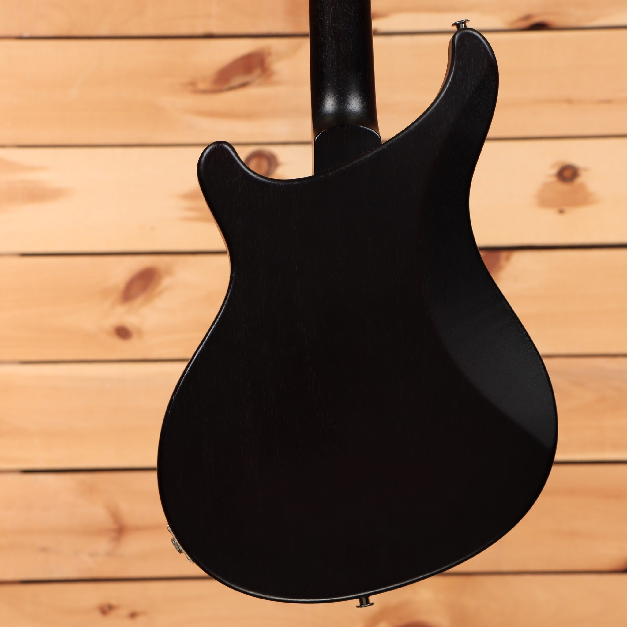 PRS S2 Vela Semi-Hollow electric guitar McCarty Burst showing satin black mahogany body back with set neck joint