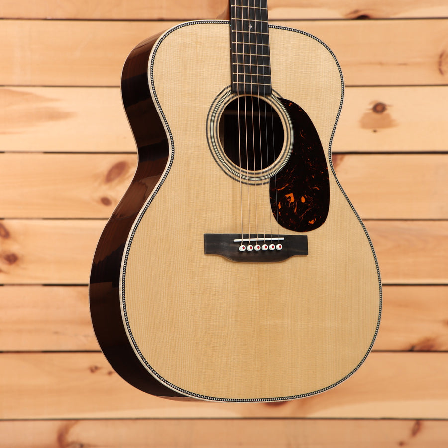 Martin 00-28 Modern Deluxe acoustic guitar natural finish with tortoiseshell pickguard and binding detail