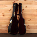 Martin OM28 Modern Deluxe acoustic guitar natural finish with gold hardware and burgundy velvet case interior