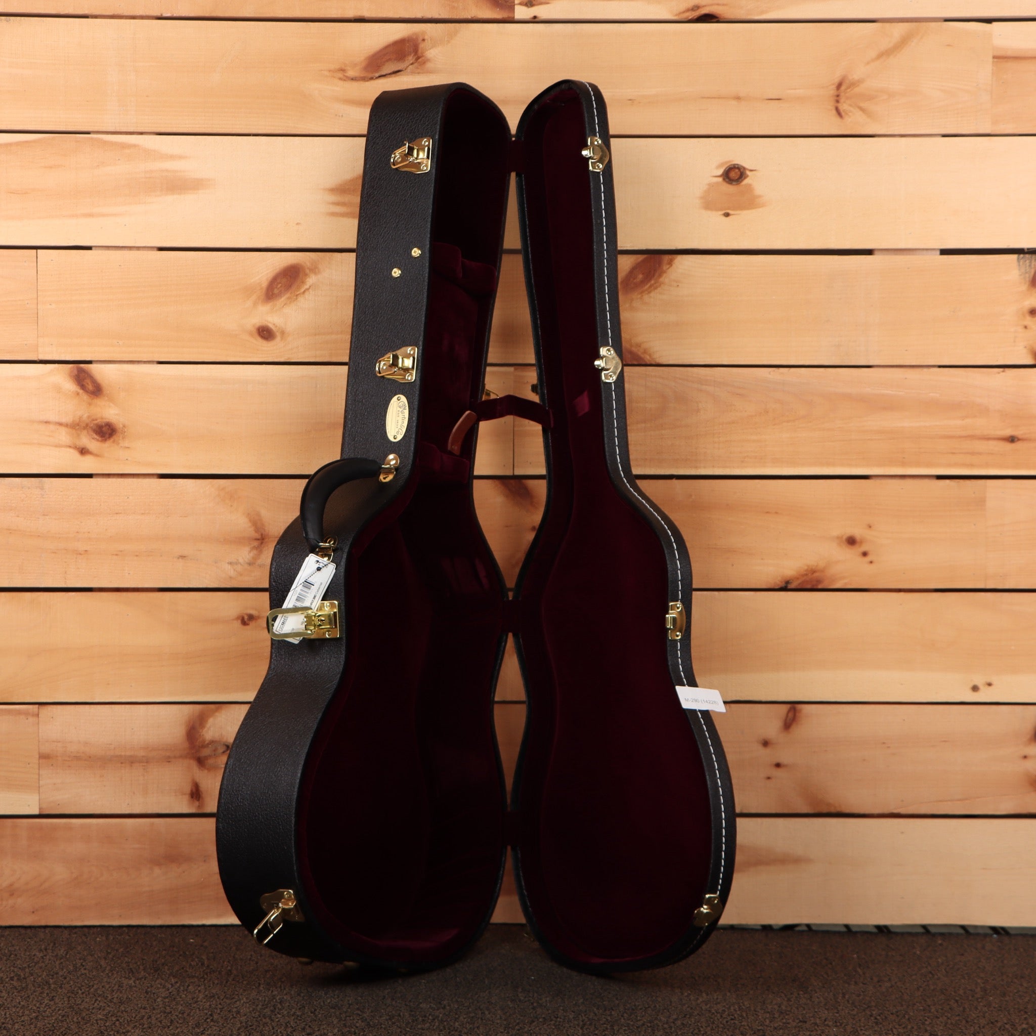 Martin OM28 Modern Deluxe acoustic guitar natural finish with gold hardware and burgundy velvet case interior