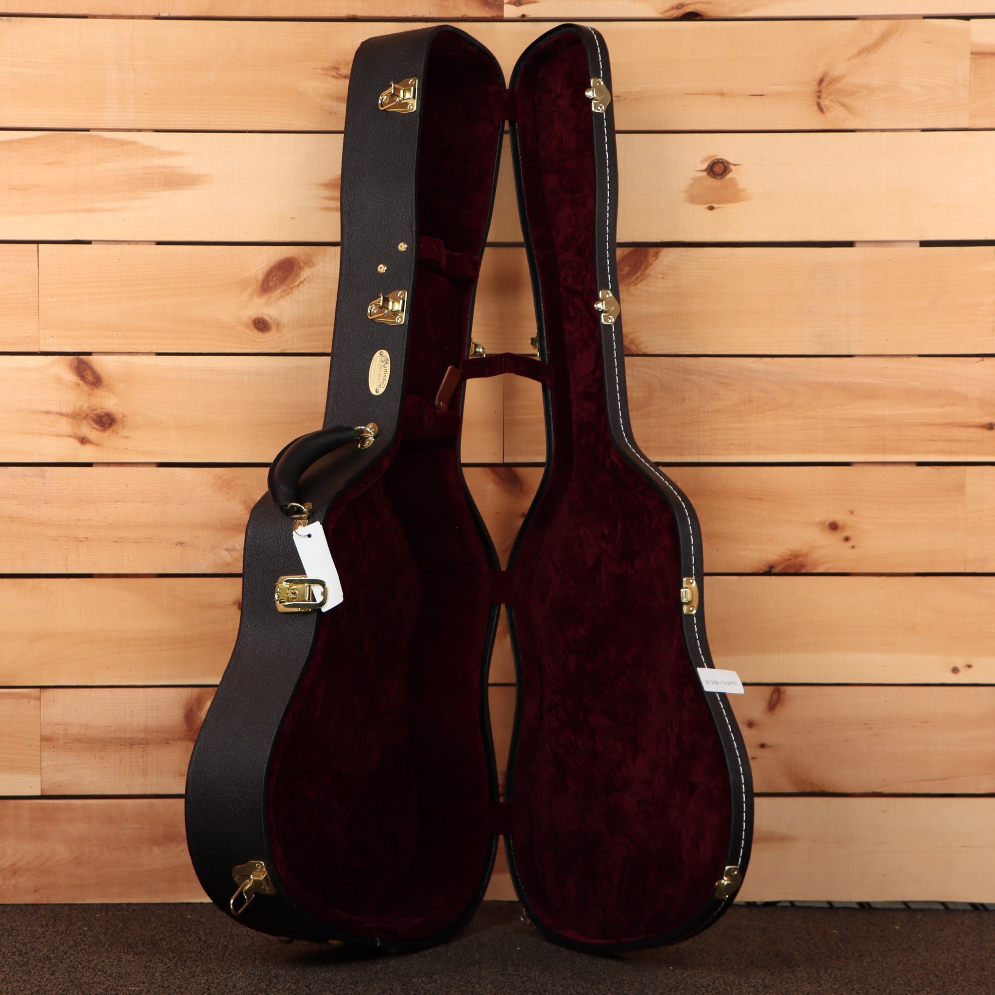 Martin 2026 NAMM Custom dreadnought acoustic guitar case with burgundy velvet interior and gold hardware