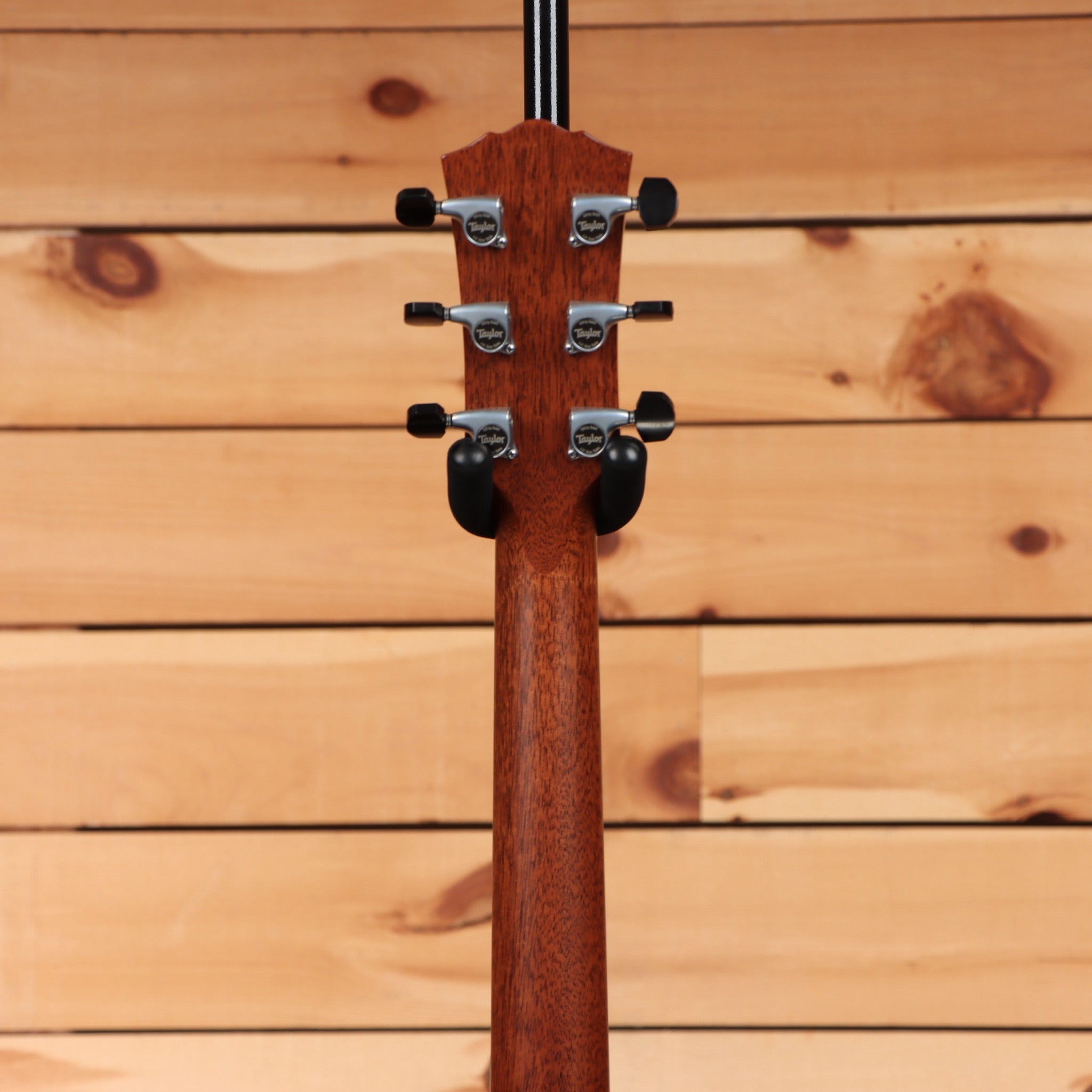 Taylor 814e Gold Label Natural acoustic-electric guitar rear headstock view with Taylor tuners and mahogany neck