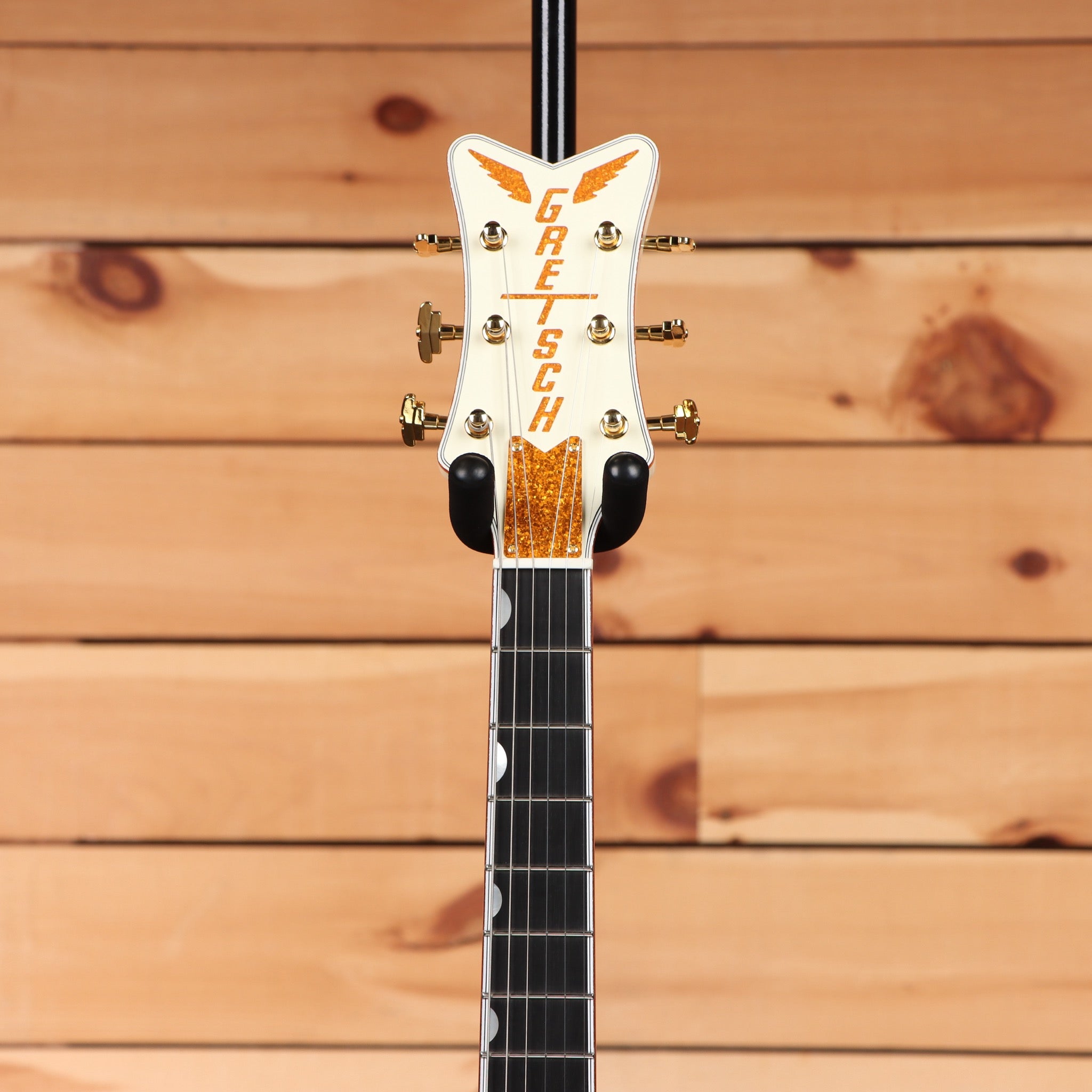 Gretsch G6134T-58 Vintage Select '58 Penguin Vintage White hollowbody guitar headstock with gold tuners and orange sparkle in