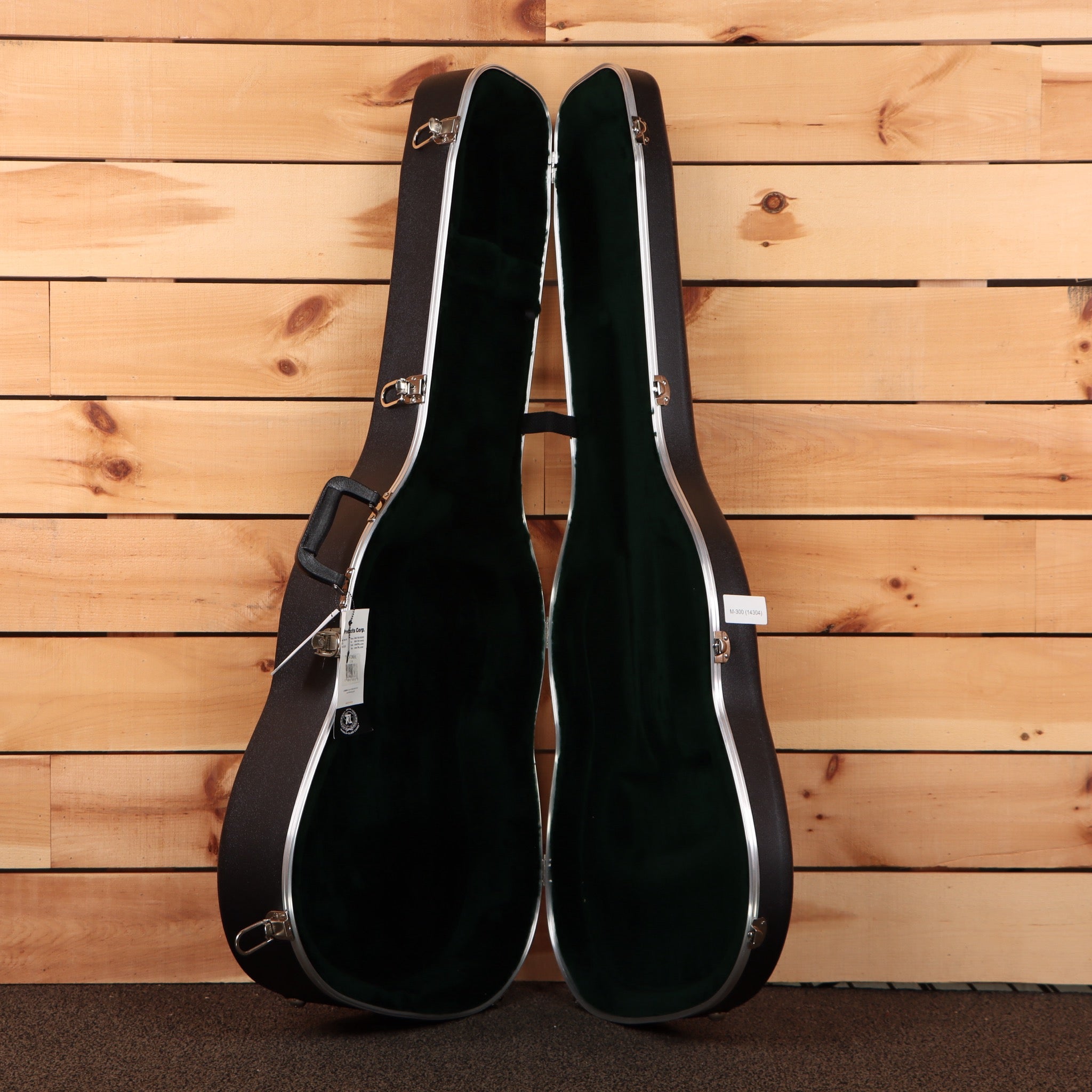 Martin D-28 Aging Toner dreadnought acoustic guitar hardshell case open showing green interior and chrome latches