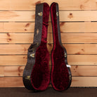 Taylor Custom Grand Pacific guitar hardshell case open showing red velvet interior with gold hardware and floral exterior