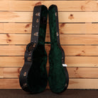 Bourgeois Downeast GAC Koa acoustic guitar hardshell case open showing green velvet interior with chrome latches