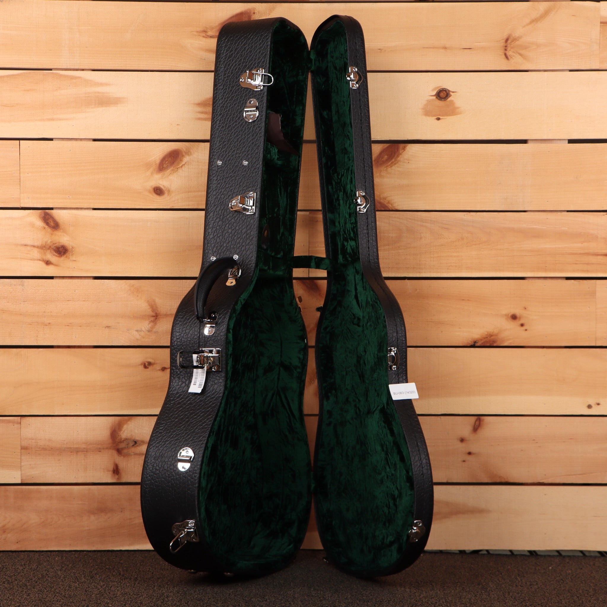 Bourgeois Downeast Slope D acoustic guitar hardshell case open showing black exterior and green velvet interior lining