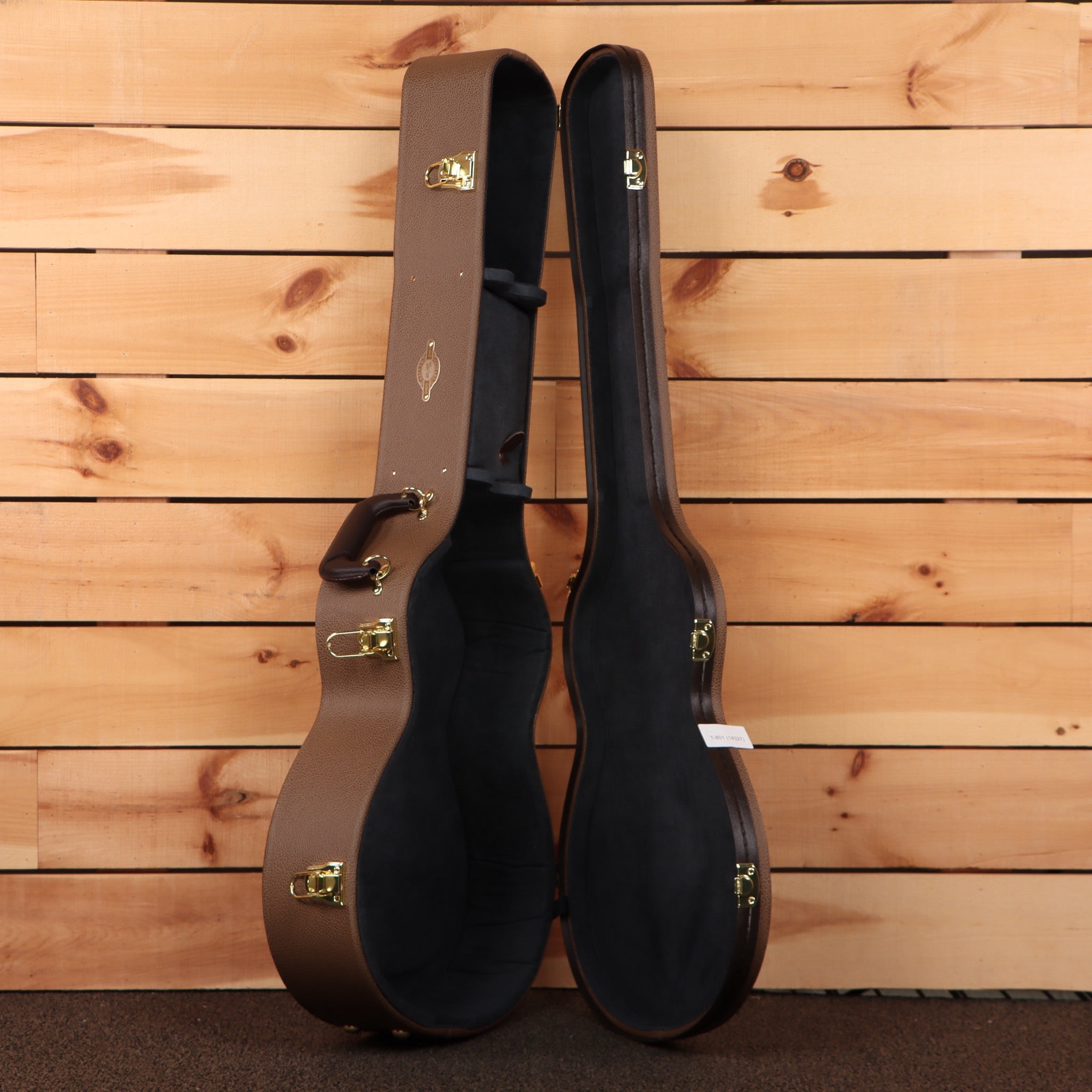 Taylor Gold Label 512e hardshell guitar case brown exterior black interior with gold hardware latches open
