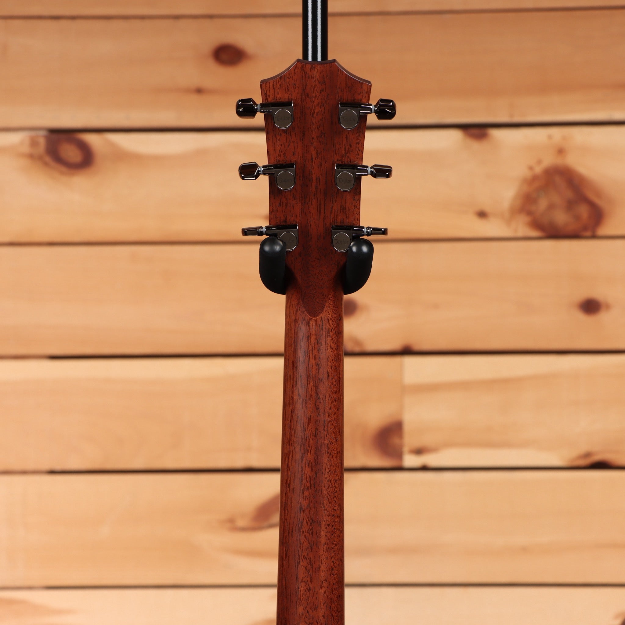 Taylor 814ce Next Generation acoustic-electric guitar Natural showing mahogany neck back of headstock with black tuning machi
