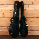 Martin Custom Shop NAMM 2026 Custom #7 1933 Ambertone hardshell guitar case open showing green velvet interior gold latches