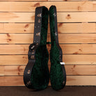 Bourgeois Touchstone OM LSH hardshell guitar case open showing black exterior and green velvet interior lining