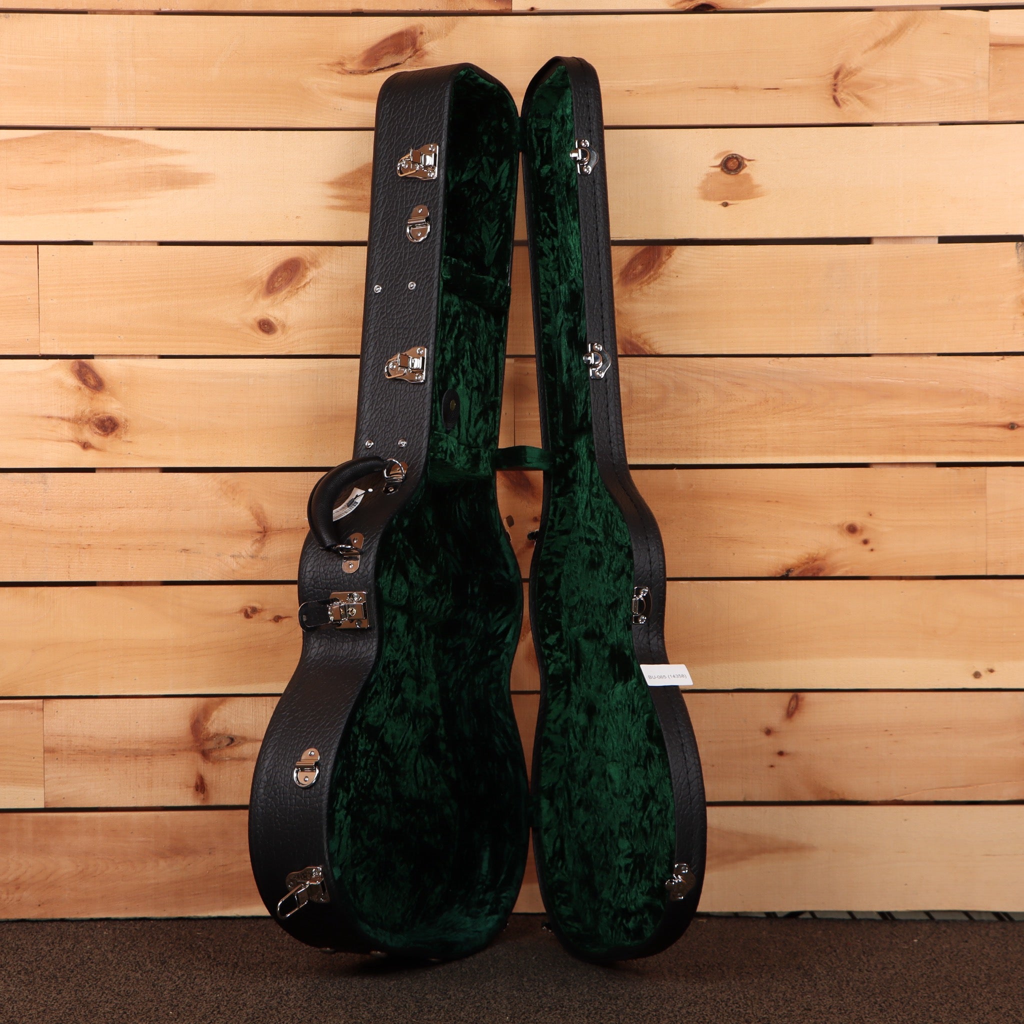 Bourgeois Touchstone OM LSH hardshell guitar case open showing black exterior and green velvet interior lining