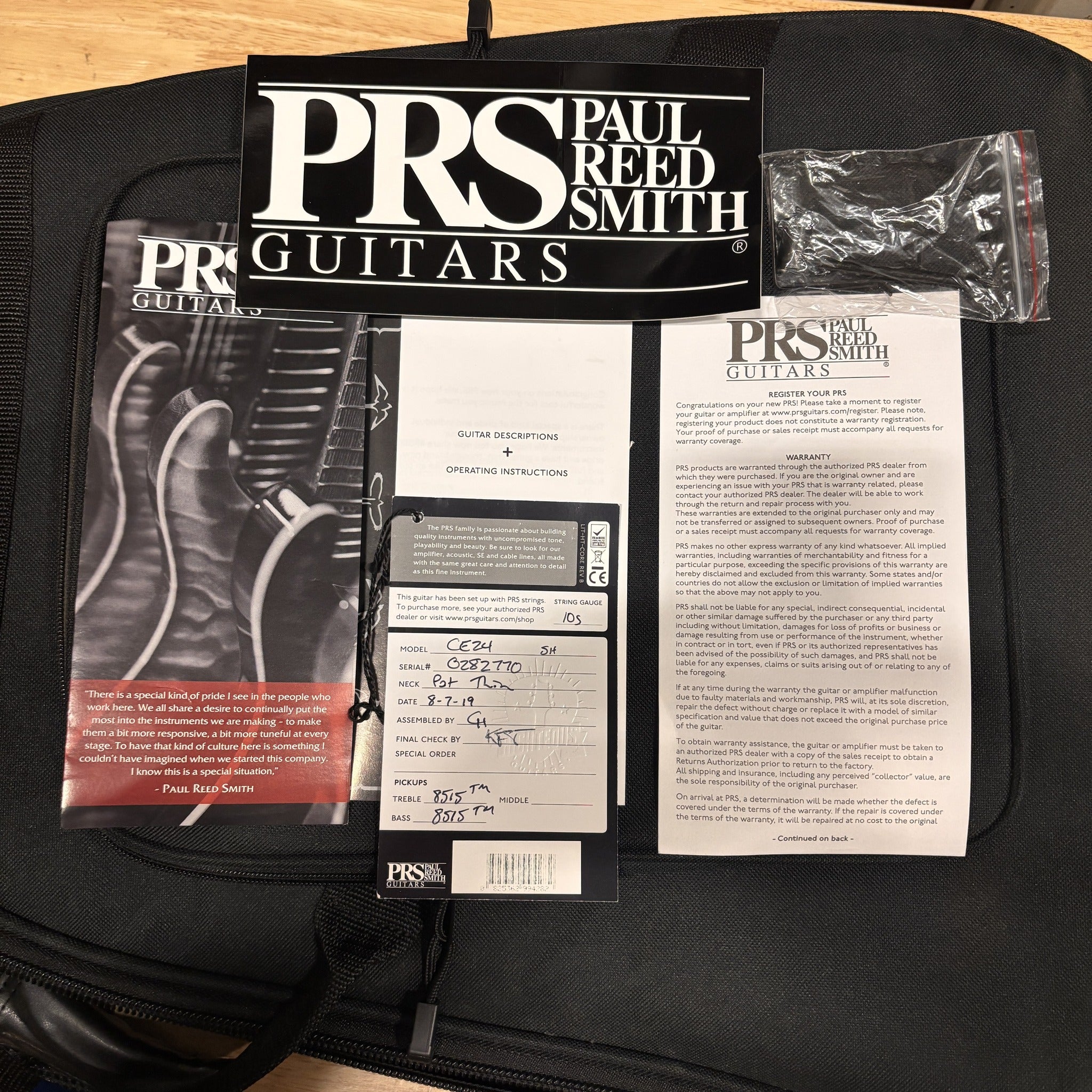 PRS CE 24 Semi-Hollow electric guitar Trampas Green with included warranty card and owner's manual documentation