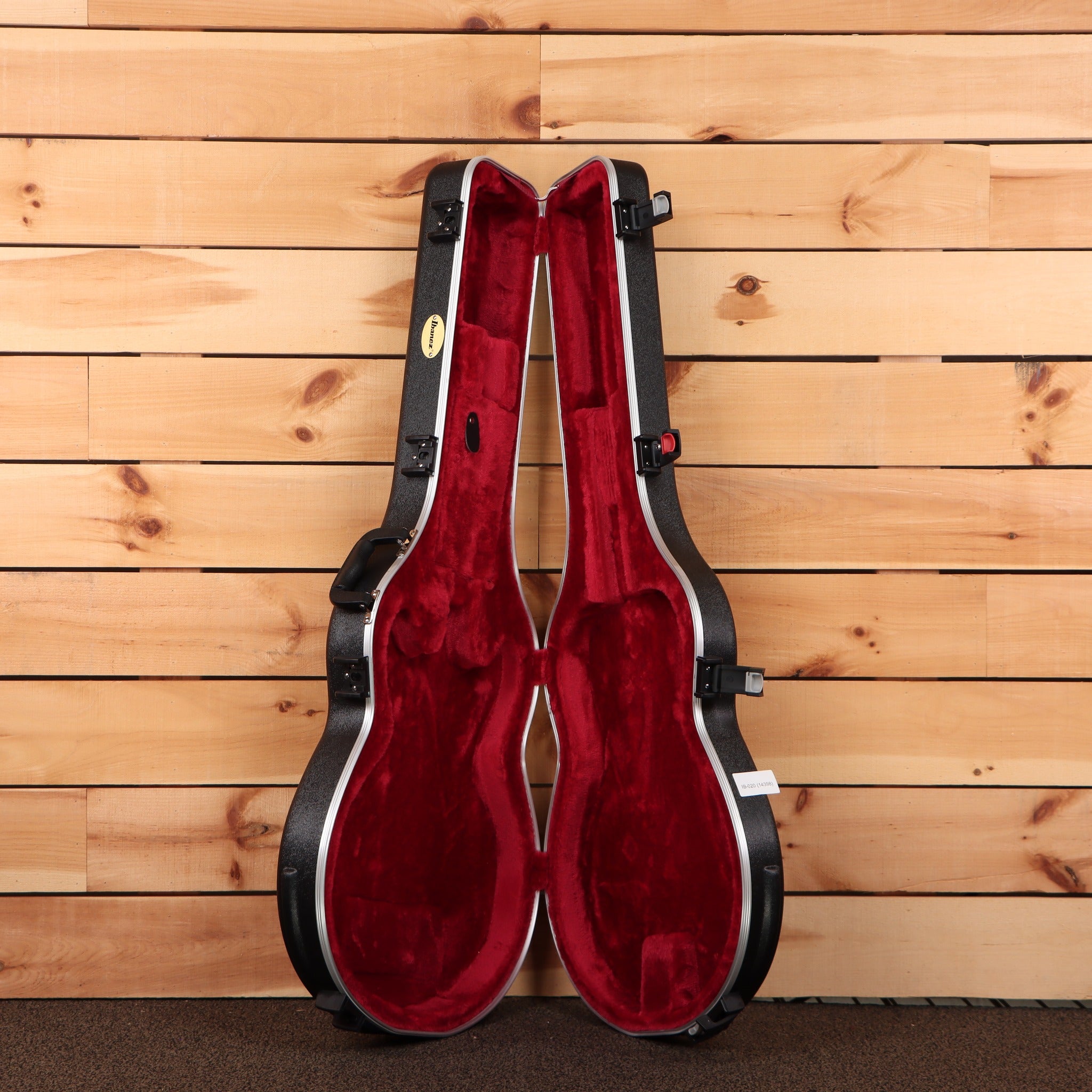 Ibanez JSM100 hollowbody guitar hardshell case open showing red velvet interior with black exterior