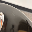 Fender American Deluxe Stratocaster HSS Montego Black body detail showing minor surface scratch near output jack