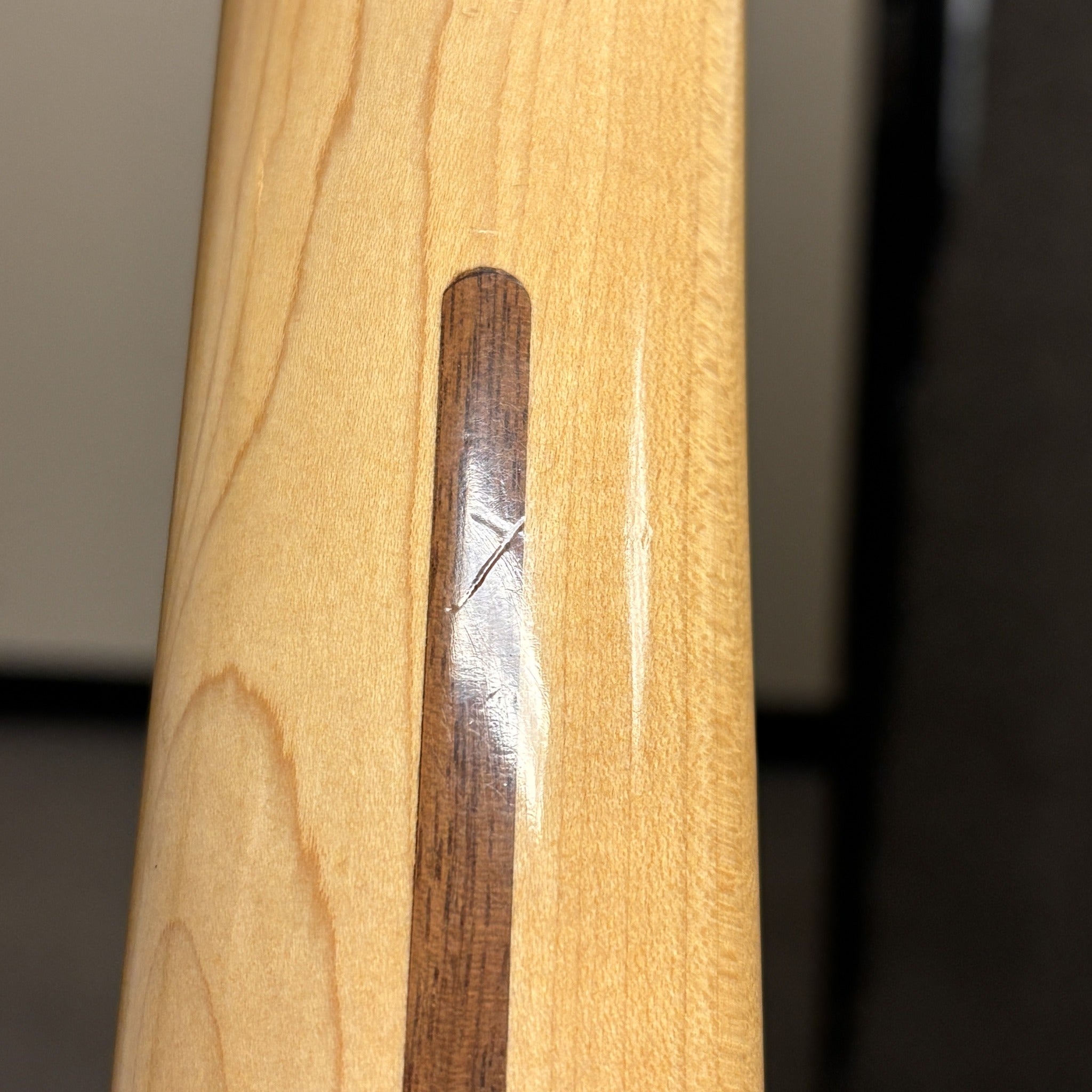 Fender American Deluxe Stratocaster HSS Montego Black maple neck close-up showing walnut skunk stripe detail