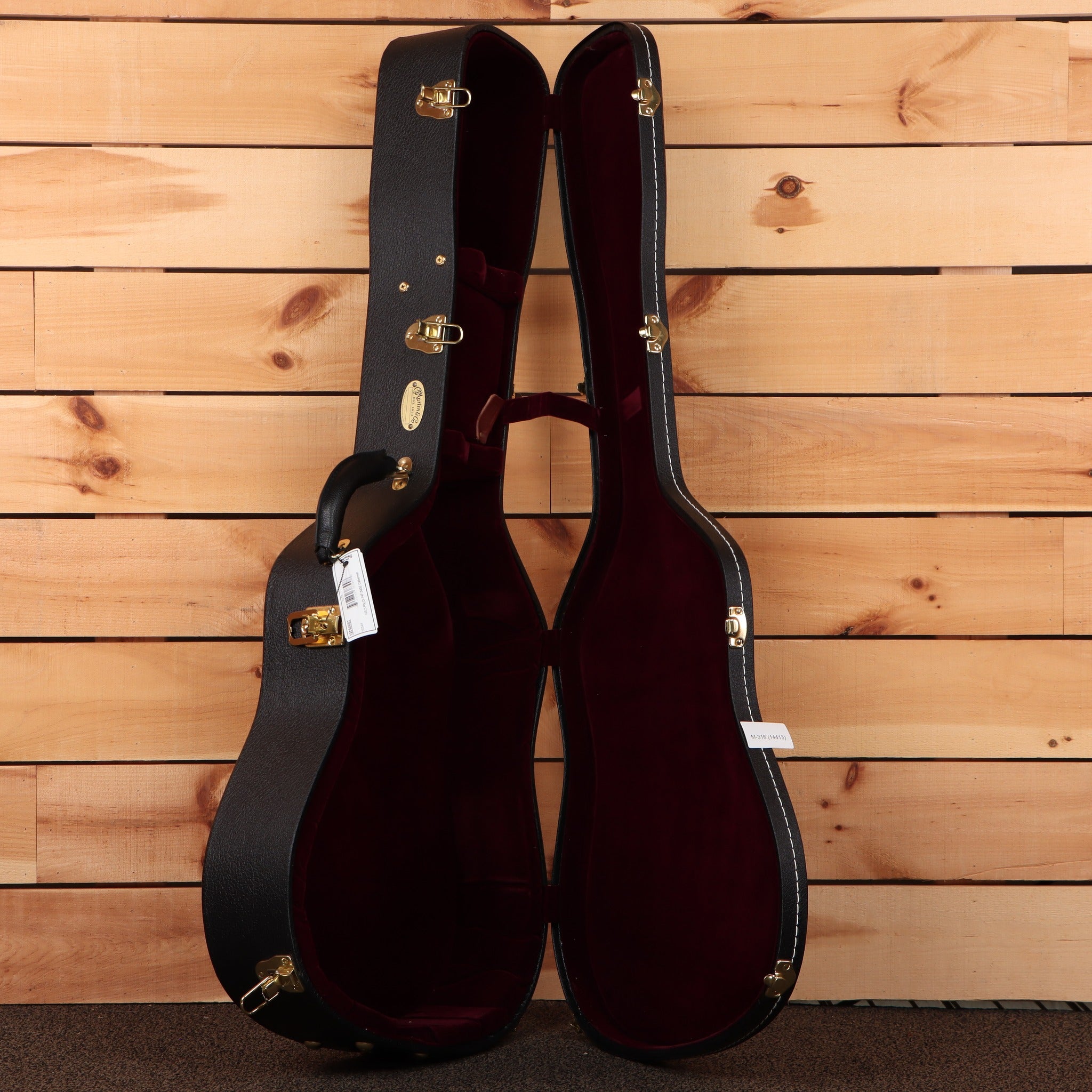 Martin D-42 acoustic guitar hardshell case black exterior with burgundy plush interior and gold hardware latches