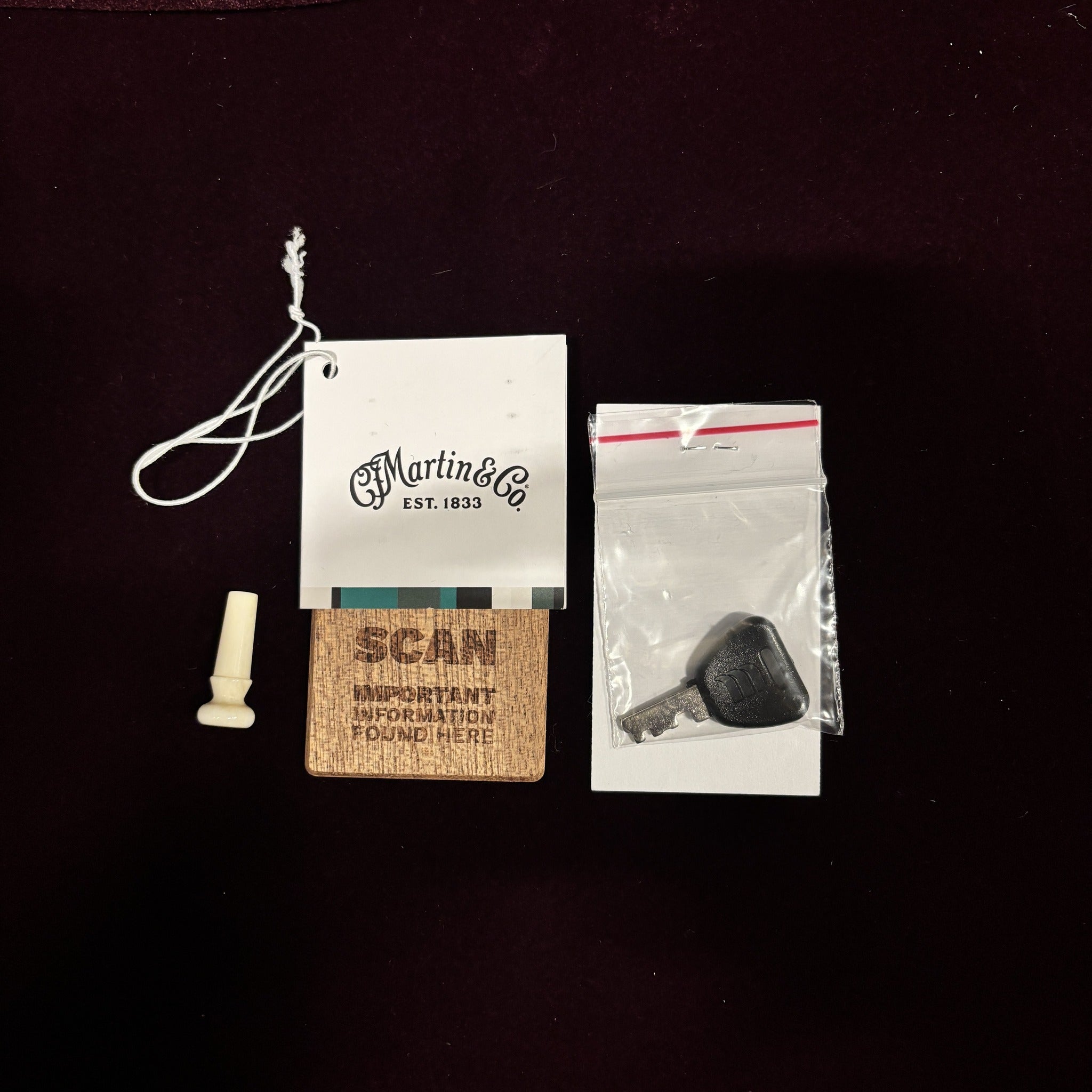 Martin D-42 Natural acoustic guitar accessories including CF Martin hang tag, strap button, case key, and QR code card