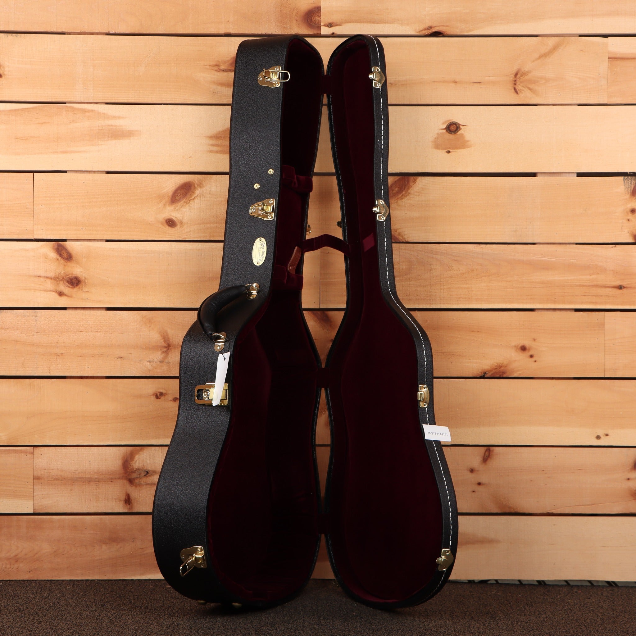 Martin D-41 Natural acoustic guitar hardshell case open showing black exterior burgundy interior and gold latches