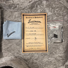 Eastman L-OMCE-QS Natural guitar certificate of authenticity with polishing cloth and strap button hardware accessories