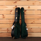 Martin 5-28 Terz guitar hardshell case open showing black exterior green velvet interior with gold hardware latches