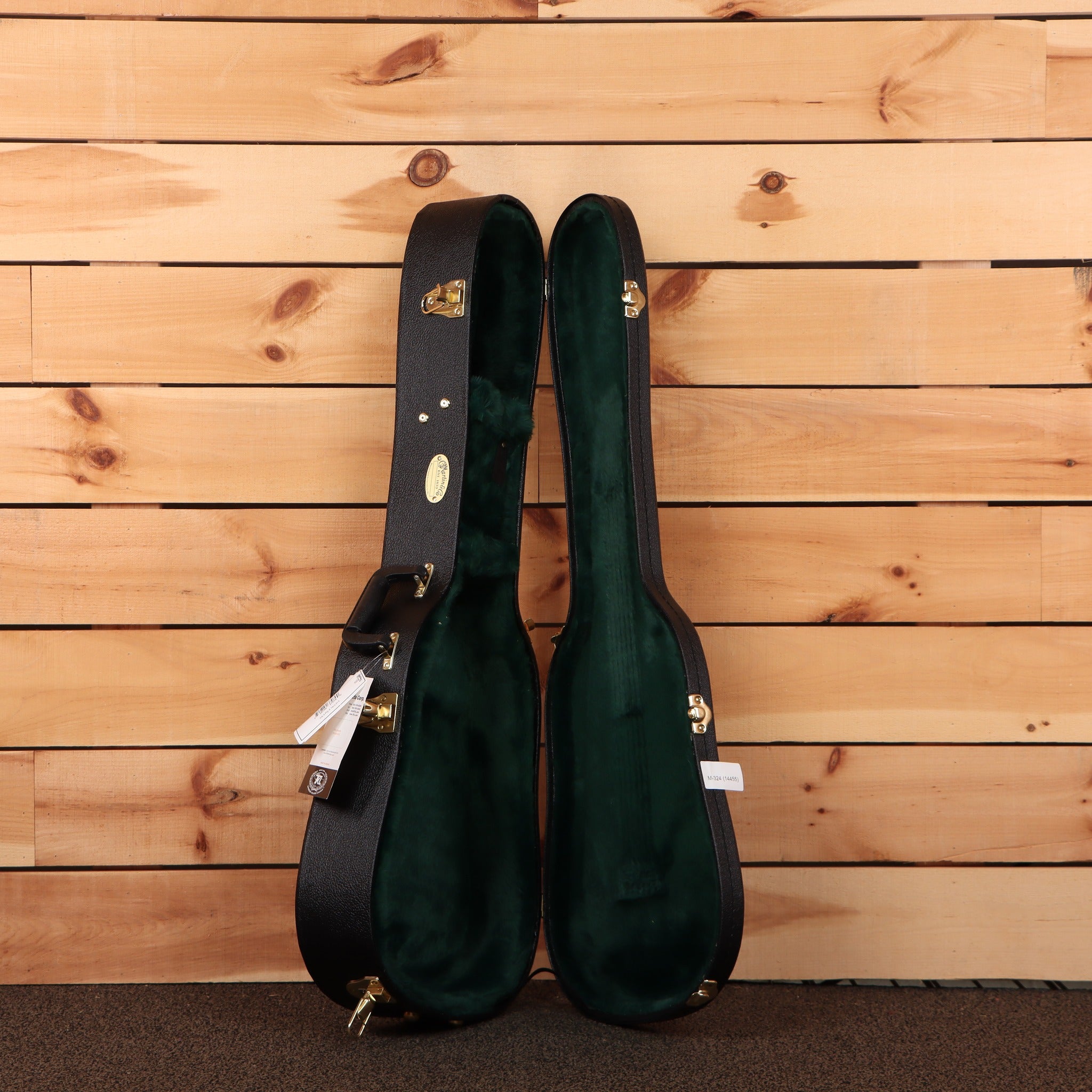 Martin 5-28 Terz guitar hardshell case open showing black exterior green velvet interior with gold hardware latches