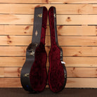 Taylor K28e Shaded Edgeburst acoustic guitar hardshell case open showing black exterior with red velvet interior and gold lat