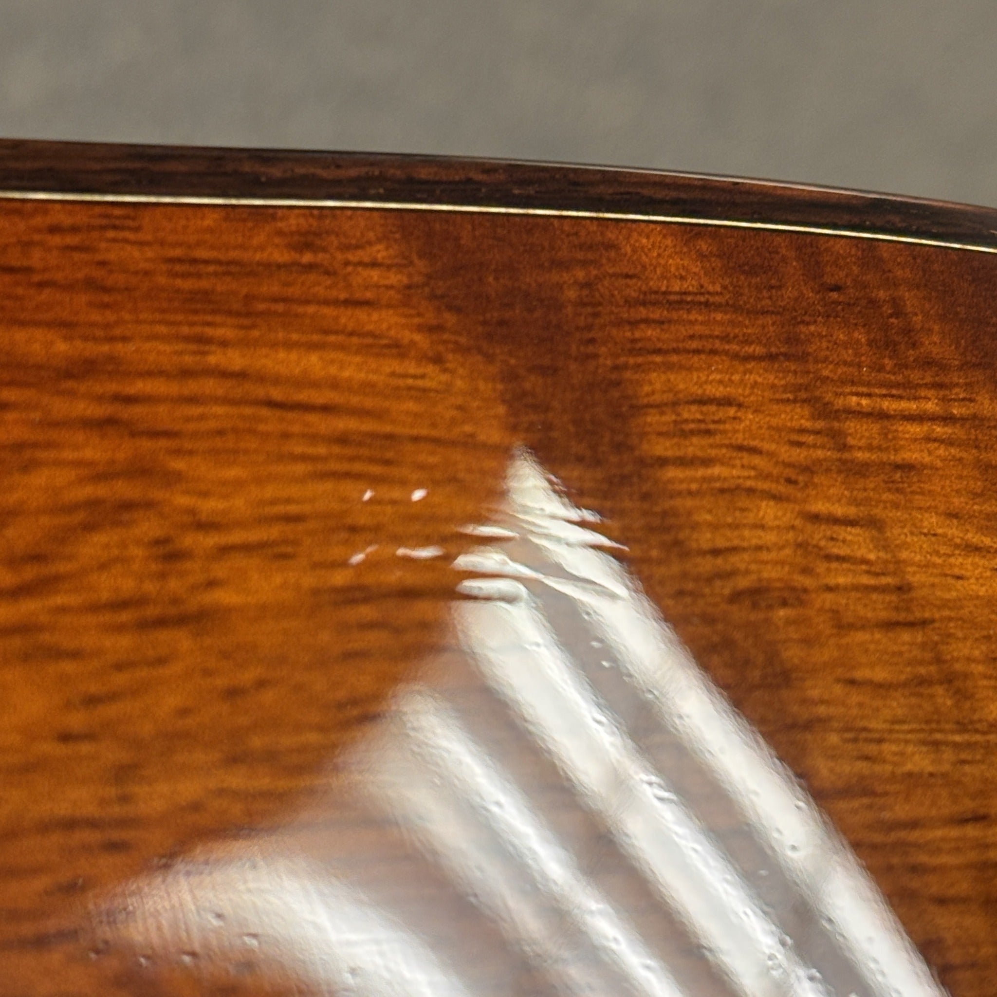 Taylor K28e acoustic-electric guitar Shaded Edgeburst showing figured koa back with visible finish crack detail