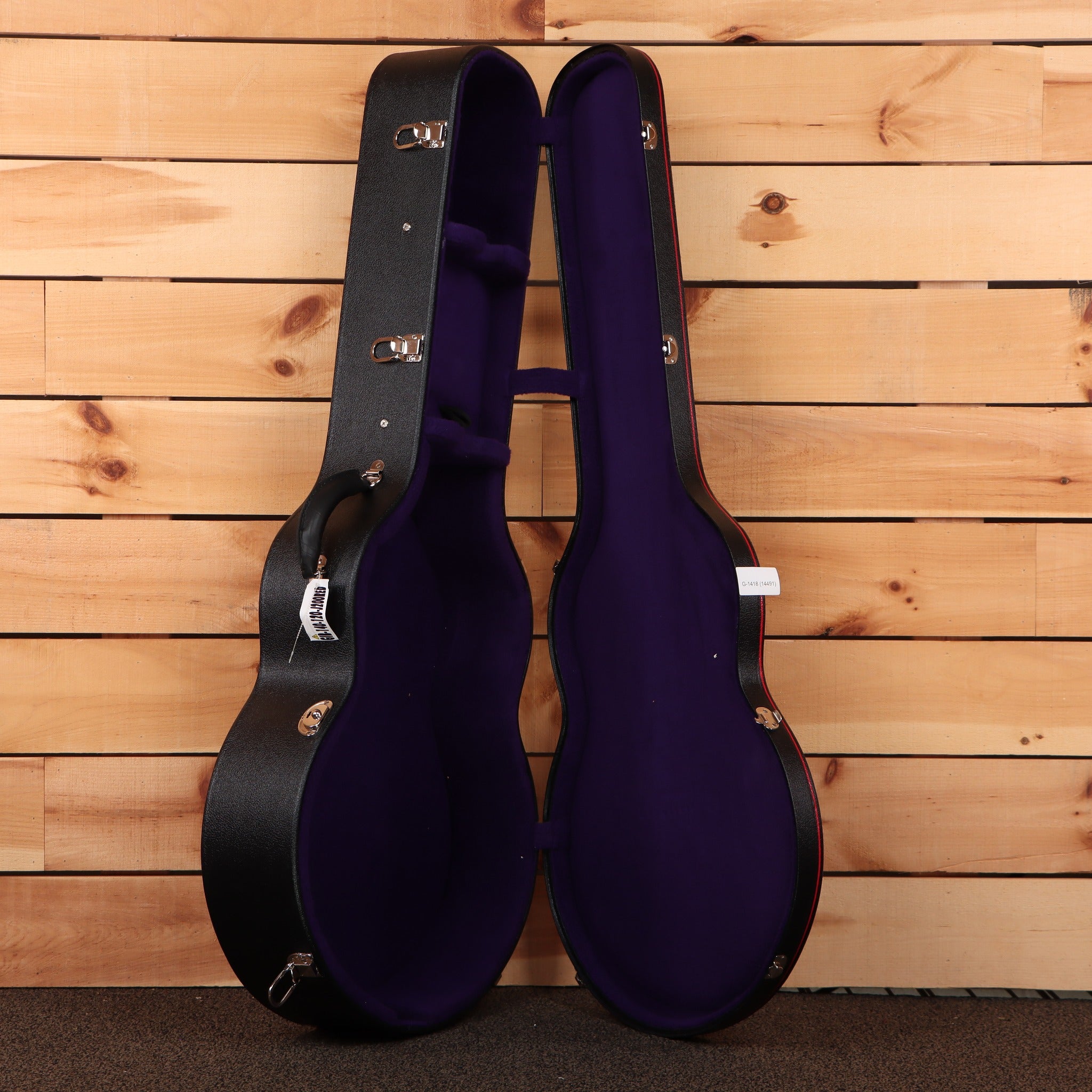 Gibson Pre-War SJ-200 Rosewood hardshell guitar case open showing purple velvet interior with chrome latches