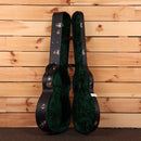 Bourgeois Touchstone Soloist OMC guitar hardshell case open showing black exterior and green velvet interior lining