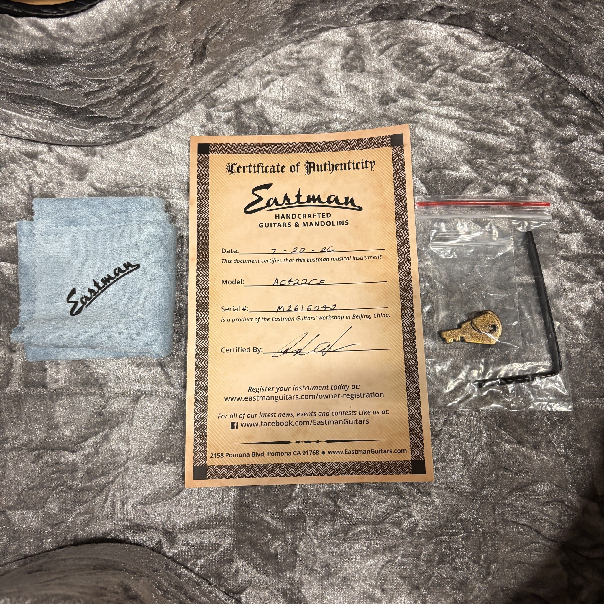 Eastman AC422CE Natural guitar certificate of authenticity with polishing cloth, truss rod wrench, and case key