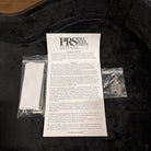 PRS SE Hollowbody Tobacco Sunburst guitar case interior with warranty card, truss rod tool, and strap button key