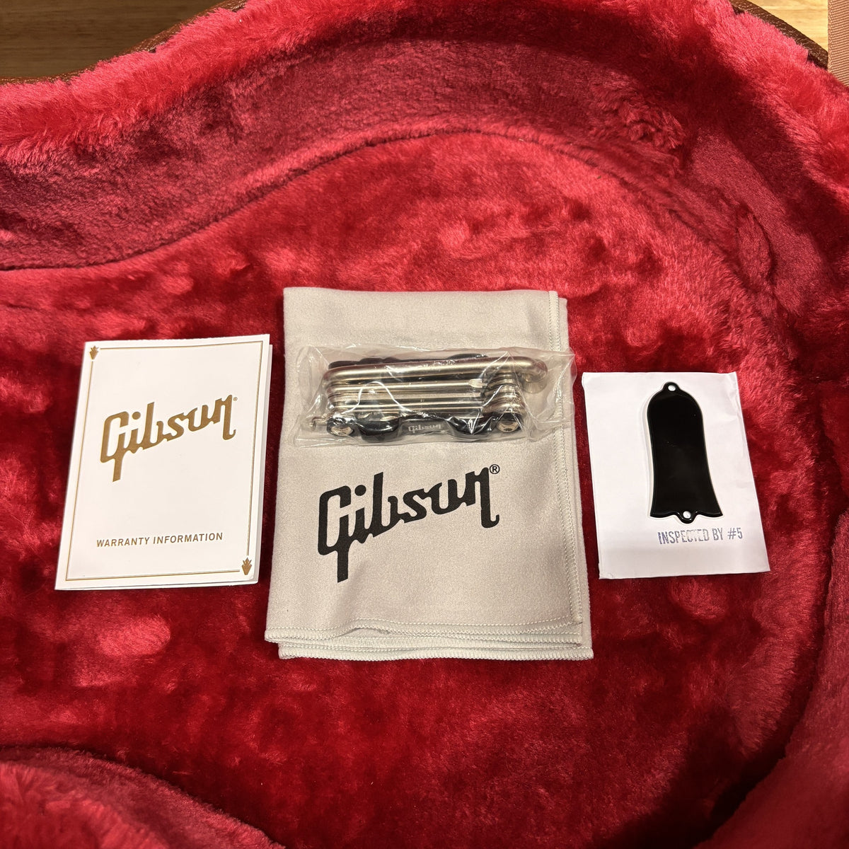 Gibson Les Paul Standard 50s TV Yellow guitar case interior with warranty card, polishing cloth, and truss rod cover